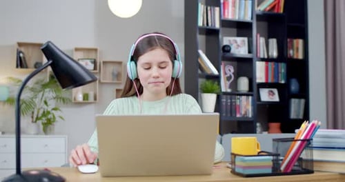Girl Uses Laptop for Online Education at Home