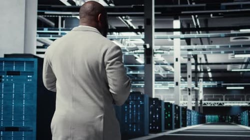 Data Center System Administrator Checks Infrastructure Diagnostics Using Tablet