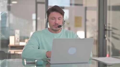 Call Center Employee with Headset Looking at Camera