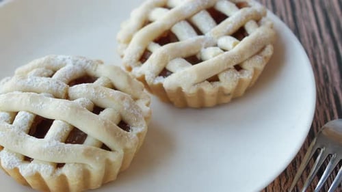 Two Powdered Sugar Tarts on Plate