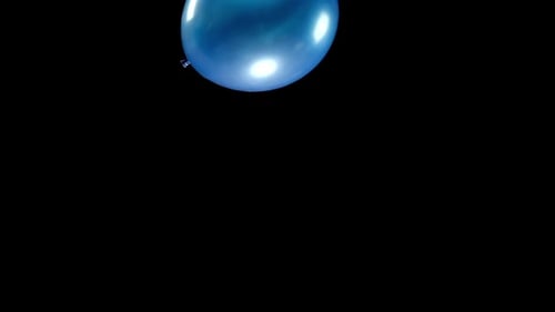 Blue Balloon Floating in the Black Background