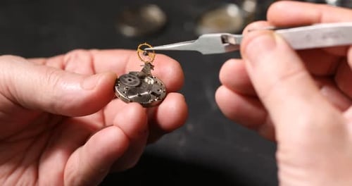 Watchmaker Assembling Intricate Watch Gears with Precision Tools