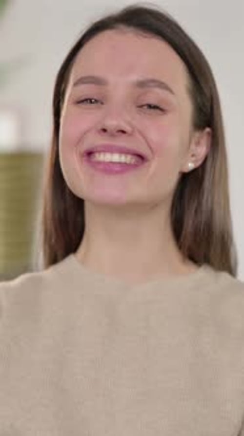 Smiling Young Woman Posing Indoors in Portrait Video