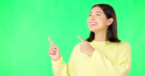 Portrait, pointing and branding with a woman on green screen space in studio for marketing