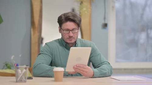 Man Using Tablet Device in Office Setting