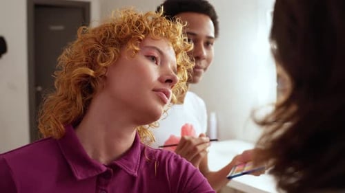 Friends Applying Makeup Together in Bright Bathroom
