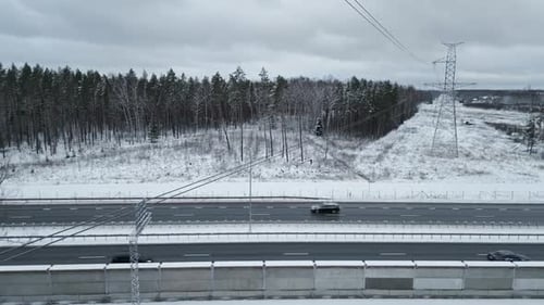 Stunning Aerial Winter Landscape Showcasing a SnowCovered Winding Road That Passes Through a