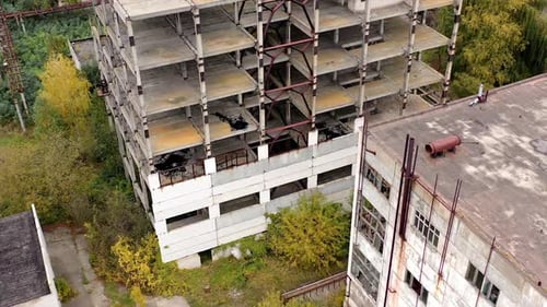 Empty destroyed factory buildings on the background. Aerial view of old abandoned factory.