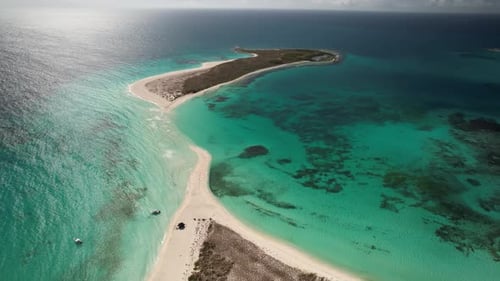 A stunning tropical island with turquoise waters and white sandy beaches, aerial view