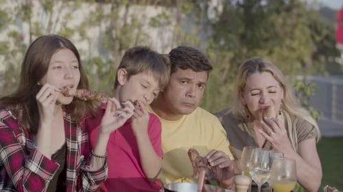 Family Enjoys Outdoor Barbecue on Sunny Day
