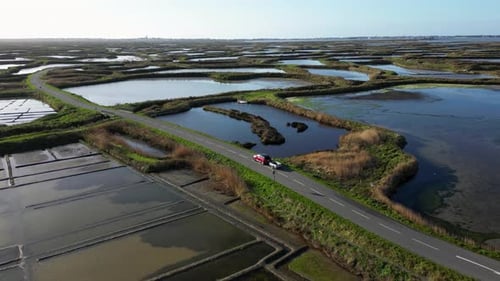 Drone is Flying Over the Salt Marshes Car Driving on a Narrow Road Guerande