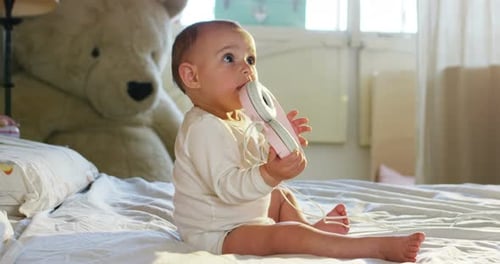 Baby Smiles with Headphones in Bedroom