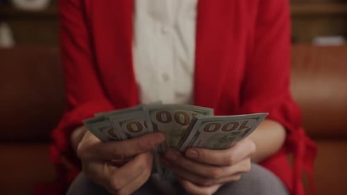 Close Up of Woman Hands Counting Cash