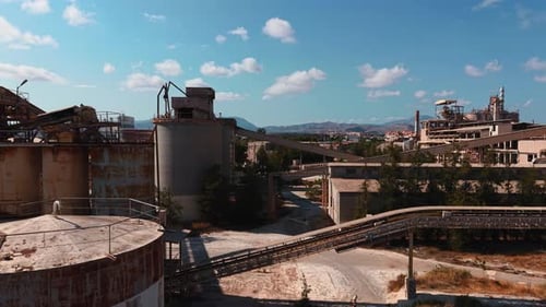 Abandoned Cement Factory Aerial View Showing Industrial Decay and Rusty Silos