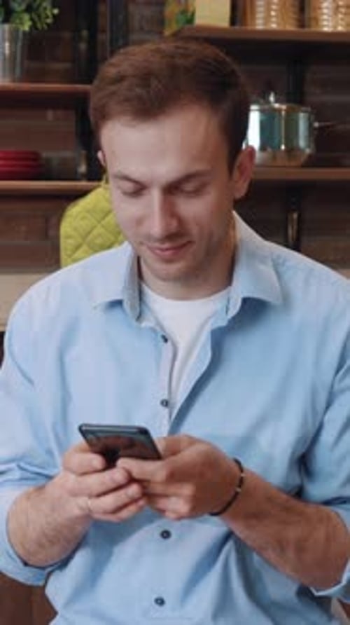Man Using Smartphone at Home in Portrait Orientation