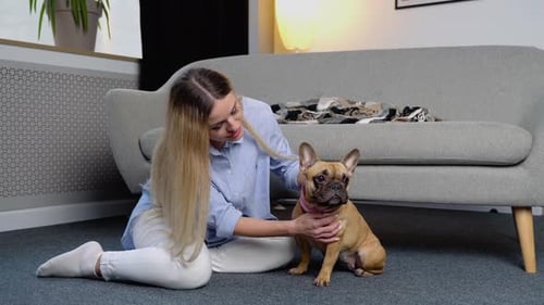 Woman Sitting with Her French Bulldog
