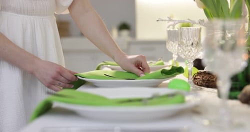 Woman Decorating an Elegant Spring Table Setting for Easter