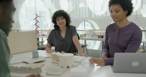 Architects in Office Discussing Urban Planning, Looking at Architecture Model