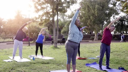 Senior sport people exercising during yoga workout class outdoor at park city - Fitness joyful