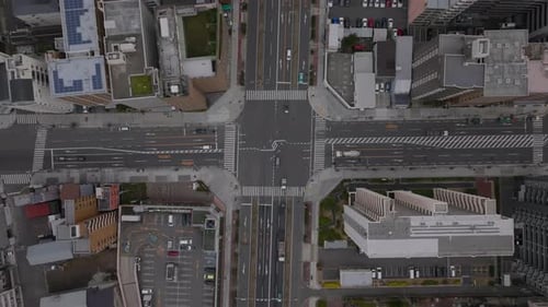 Top Down Footage of Cars Passing Through Road Intersection in Urban Borough High Density of Town