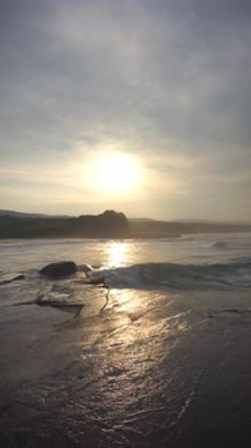 big waves of sea water during low tide in the morning at sunrise