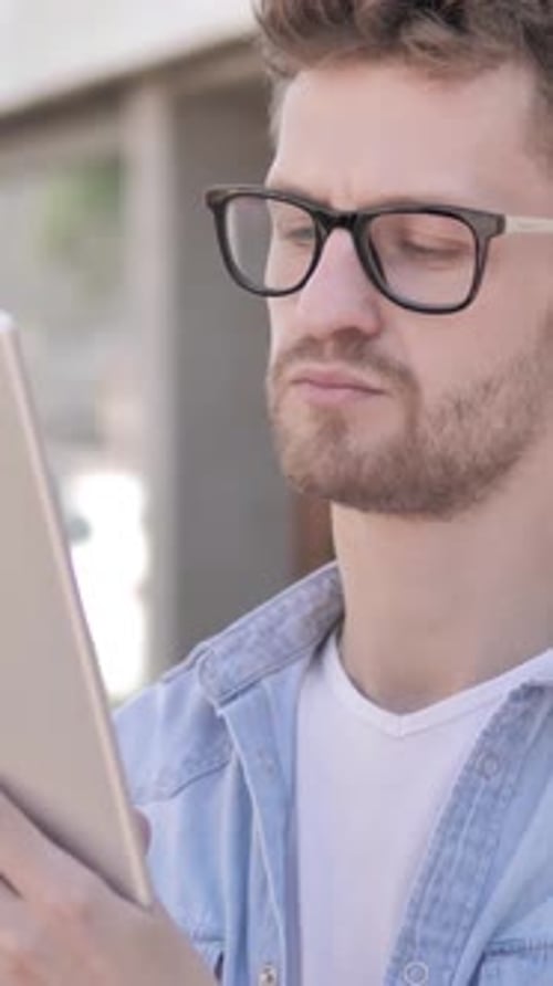 Casual Young Man Using Tablet while Standing Outdoor, Vertical Video