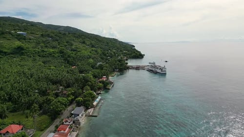 Majestic Coastal Philippines Small Island Town with Road Truck Pier and Ferry Aerial Shot