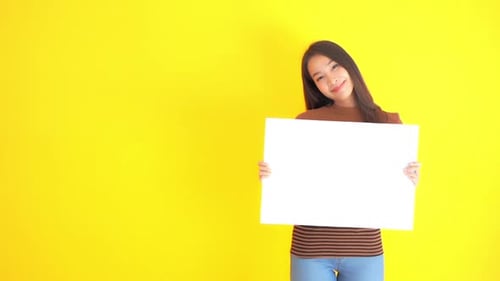 Smiling Woman Holding Blank White Sign on Yellow