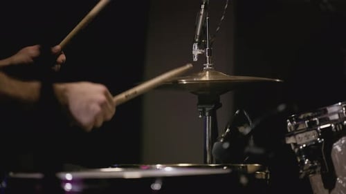 A Young Caucasian Man Drummer Plays a Drum Kit in a Music Studio