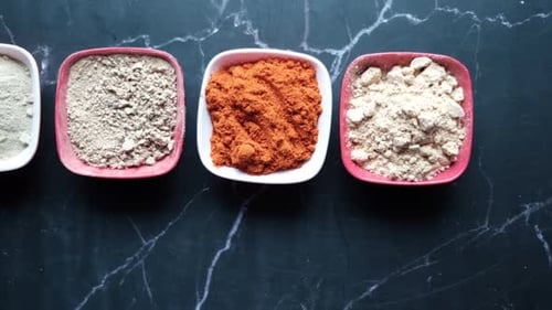 Vibrant Cooking Spices Displayed in Square Bowls