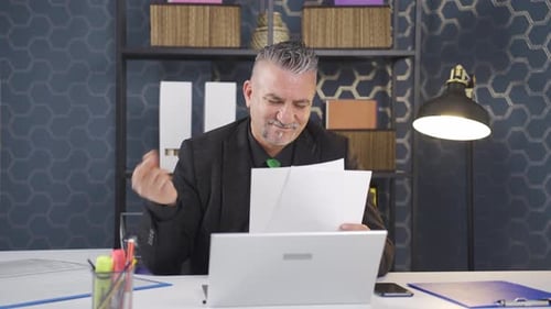 Businessman rejoicing at positive paperwork results.
