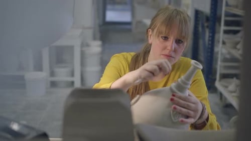 Female artist carving crafts product in workshop