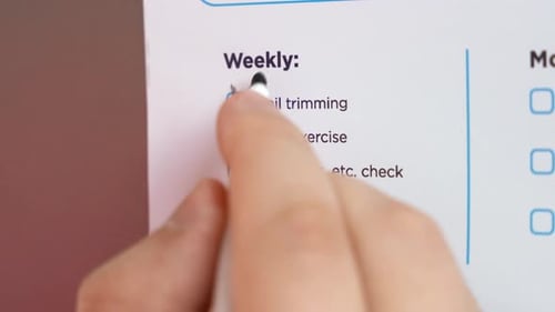 Person removes completed tasks from schedule list ticking