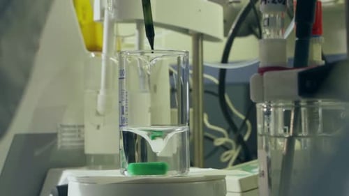 Lab Assistant Does Experiment with Crude Oil in Workshop