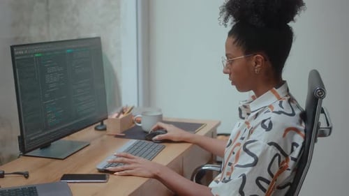 Female IT Specialist Coding on Computer in the Office