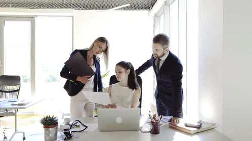 Three Business People in the Office Working Together