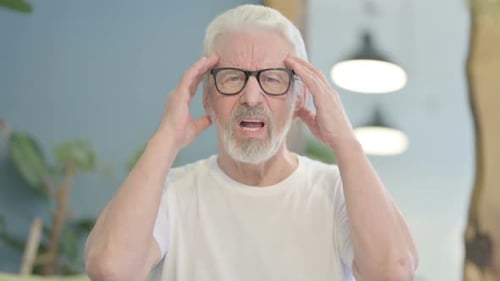Senior Man Experiencing Headache, Rubbing Temples