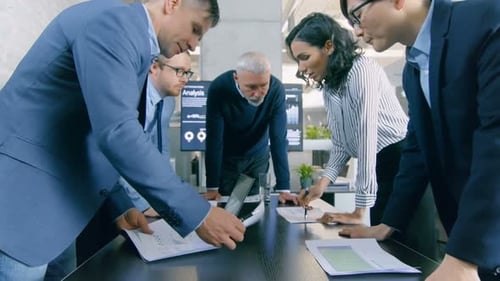 Diverse Team Collaborating on Project in Modern Office