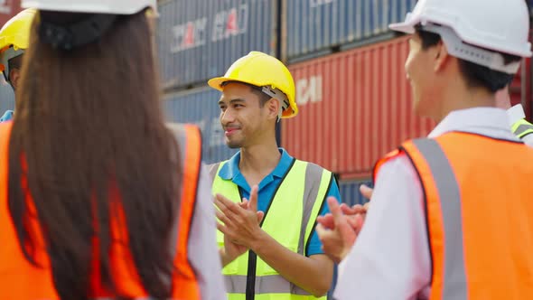 Group of man and woman worker clap hands while work in container port ...