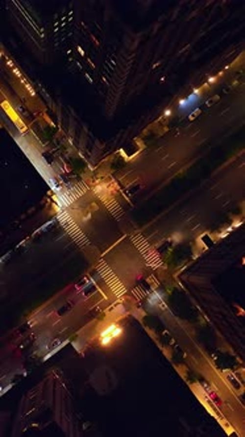 Narrow and wide road crossing between the skyscrapers. Transport going along the streets