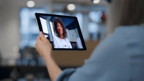 Woman Watching Video Training on Pad Computer at Home Close Up Calling Online