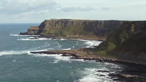 Aerial view of the Giant's Causeway on a sunny day, County Antrim, Northern Ireland. Flying away fro