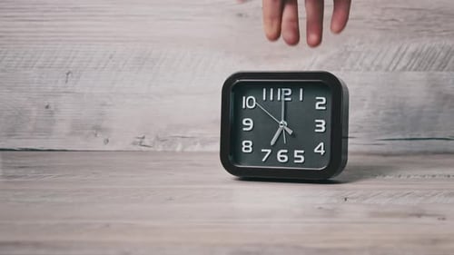 Male Hand Puts an Arrow Mechanical Watch on a Wooden Table