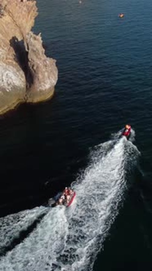 Jet Skis Cruising on Ocean Near Cliffs, Aerial View