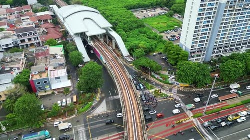 Aerial View of Cityscape with Tall Buildings, MRT Rail, and Traffic on Roads