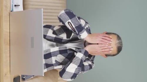 Vertical video of Unsuccessful old man.