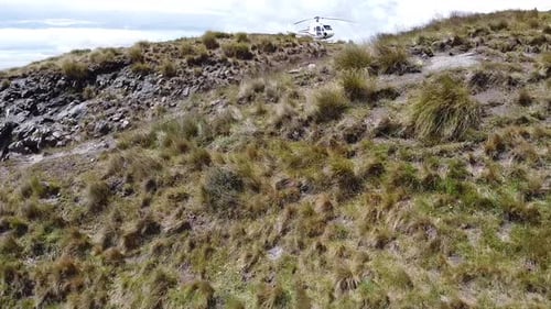 flying towards a helicopter on the mountain autumn grass