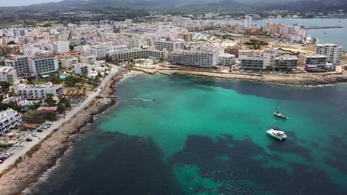 Aerial drone footage of the town of Sant Antoni de Portmany on the west coast of Ibiza in Spain