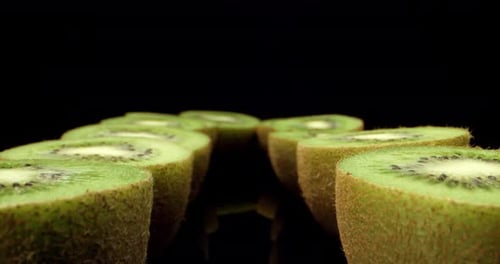 Green fresh kiwi fruit cut in half super close up shoot fly over laowa 4k high quallity