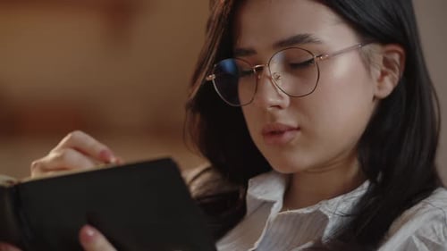 Woman Writing in Notebook Close Up Indoors
